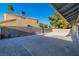 A concrete patio is surrounded by gravel in this sunny backyard with tall block wall fencing for privacy at 6248 Spanish Moss Ave, Las Vegas, NV 89108