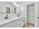 Bright bathroom featuring dual sinks, white cabinetry, and a modern design at 6248 Spanish Moss Ave, Las Vegas, NV 89108