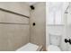 Tiled shower featuring black hardware and a built-in shelf, next to a toilet at 6248 Spanish Moss Ave, Las Vegas, NV 89108