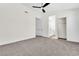 Spacious carpeted bedroom with ceiling fan and view into bathroom at 6248 Spanish Moss Ave, Las Vegas, NV 89108
