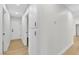 Hallway featuring hardwood floors, with a view of the front door and built in shelves at 6248 Spanish Moss Ave, Las Vegas, NV 89108