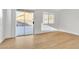 Bright living room featuring hardwood floors, natural light, and a sliding glass door to the backyard at 6248 Spanish Moss Ave, Las Vegas, NV 89108