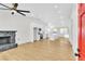 Open living space featuring a modern kitchen, stone fireplace, and natural light at 6248 Spanish Moss Ave, Las Vegas, NV 89108