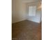 A bright, empty bedroom with tiled floors, a window with blinds, and neutral walls at 6868 Sky Pointe Dr # 1034, Las Vegas, NV 89131