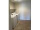 Simple laundry room featuring a washer, dryer, a shelf, and tiled flooring at 6868 Sky Pointe Dr # 1034, Las Vegas, NV 89131