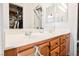 Bathroom featuring double sinks, wood cabinets, and decorative mirrors, offering both style and functionality at 6901 Squaw Mountain Dr # 201, Las Vegas, NV 89130