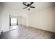 This bedroom has a ceiling fan, mirrored closet doors, and laminate floors at 6901 Squaw Mountain Dr # 201, Las Vegas, NV 89130