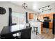 A dining area and kitchen featuring a dark wood table and black appliances at 6901 Squaw Mountain Dr # 201, Las Vegas, NV 89130