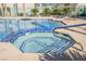 Hot tub with tiled accents and metal railing, located next to a swimming pool at 6901 Squaw Mountain Dr # 201, Las Vegas, NV 89130