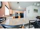 Kitchen with a granite counter top, black appliances and wooden cabinetry at 6901 Squaw Mountain Dr # 201, Las Vegas, NV 89130