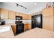 A kitchen with light wood cabinets and black appliances offering a functional cooking area at 6901 Squaw Mountain Dr # 201, Las Vegas, NV 89130