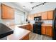 A kitchen featuring light wood cabinets and black appliances providing a functional cooking space at 6901 Squaw Mountain Dr # 201, Las Vegas, NV 89130