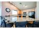 Kitchen featuring granite countertops, black appliances, and wooden cabinets under track lighting at 6901 Squaw Mountain Dr # 201, Las Vegas, NV 89130