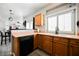 Cozy kitchen featuring wood cabinets, black appliances, and a window for natural light at 6901 Squaw Mountain Dr # 201, Las Vegas, NV 89130