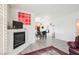 Bright living room view looking into dining area with open floor plan, fireplace, and light filled space at 6901 Squaw Mountain Dr # 201, Las Vegas, NV 89130