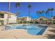 Swimming pool with lounge chairs, tables and apartments in the background at 6901 Squaw Mountain Dr # 201, Las Vegas, NV 89130