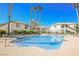 Community pool surrounded by lush palm trees and well-maintained landscaping at 6901 Squaw Mountain Dr # 201, Las Vegas, NV 89130