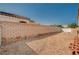 Gravel-covered backyard featuring a solid brick wall, offering privacy and low-maintenance landscaping at 713 Salt Flats Cir, Henderson, NV 89011