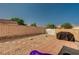Backyard area with desert landscaping, featuring a small patio, rock features, and privacy fencing at 713 Salt Flats Cir, Henderson, NV 89011