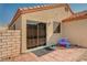 Enclosed backyard features a sliding glass door, small patio, gravel landscaping, and privacy fencing at 713 Salt Flats Cir, Henderson, NV 89011