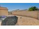Backyard showcasing a tiled patio, gravel landscaping, brick wall, and partial view of the house at 713 Salt Flats Cir, Henderson, NV 89011