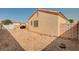 Backyard featuring gravel landscaping, privacy wall, and the home's exterior walls and roof at 713 Salt Flats Cir, Henderson, NV 89011