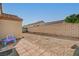 Cozy backyard showcasing a brick-paved patio area, low-maintenance gravel landscaping, and a charming brick wall at 713 Salt Flats Cir, Henderson, NV 89011