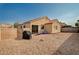 Wide angle shot of a backyard featuring tiled patio, gravel landscaping, and privacy fencing at 713 Salt Flats Cir, Henderson, NV 89011