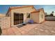 Private backyard featuring a small patio, gravel landscaping, privacy wall, and desert plants at 713 Salt Flats Cir, Henderson, NV 89011