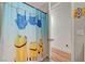 Up close view of a playful bathroom with a unique shower curtain and modern fixtures at 713 Salt Flats Cir, Henderson, NV 89011