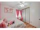 Bright bedroom featuring wood-look floors, a desk, closet and a large window at 713 Salt Flats Cir, Henderson, NV 89011