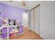 Bedroom features wood-look floors, playful decor, and a closet with sliding doors at 713 Salt Flats Cir, Henderson, NV 89011