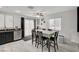 Bright dining area featuring a large table, tile floors, and access to the kitchen at 713 Salt Flats Cir, Henderson, NV 89011