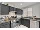 This updated kitchen showcases stainless steel appliances, dark cabinets, and modern backsplash at 713 Salt Flats Cir, Henderson, NV 89011
