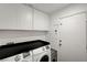 Functional laundry room features modern washer and dryer, built-in cabinets for storage at 713 Salt Flats Cir, Henderson, NV 89011