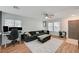 Inviting living area with a ceiling fan, wood floors, and a comfortable sectional sofa at 713 Salt Flats Cir, Henderson, NV 89011