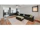 Bright living room featuring wood floors, a comfortable sofa, and an open-concept design at 713 Salt Flats Cir, Henderson, NV 89011