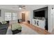 Cozy living room featuring a ceiling fan, wood floors, and a comfortable sofa at 713 Salt Flats Cir, Henderson, NV 89011