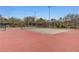 Outdoor tennis court with well-maintained surface and surrounding trees in a community park at 713 Salt Flats Cir, Henderson, NV 89011