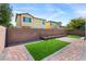 Beautiful backyard with pavers, artificial grass, a planter, and a privacy wall at 7348 Zion Falls St, Las Vegas, NV 89131