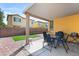 Relaxing backyard featuring a covered patio, pavers, artificial grass, and barbecue at 7348 Zion Falls St, Las Vegas, NV 89131