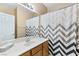 Well-lit bathroom featuring a large mirror and stylish shower curtain at 7348 Zion Falls St, Las Vegas, NV 89131