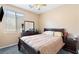 Comfortable bedroom featuring a ceiling fan, large window, and dark wood furnishings at 7348 Zion Falls St, Las Vegas, NV 89131