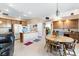 Well-lit kitchen with island, tile floors, and ample cabinetry, seamlessly connected to an open dining area at 7348 Zion Falls St, Las Vegas, NV 89131
