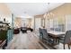 Bright living room with wood-look floors, stylish chandelier, and a cozy dining area for relaxed gatherings at 7348 Zion Falls St, Las Vegas, NV 89131