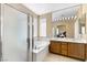 Luxurious bathroom featuring double sinks, a soaking tub, and a glass-enclosed shower, creating a spa-like experience at 7348 Zion Falls St, Las Vegas, NV 89131
