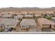 Aerial view of a single-Gathering home with desert landscaping, a two-car garage, and a tiled roof at 7525 Campbell Ranch Ave, Las Vegas, NV 89179