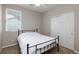 Well-lit bedroom features a window, neutral walls, carpeted floor, closet, and simple furnishings at 7525 Campbell Ranch Ave, Las Vegas, NV 89179