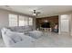 Bright living room with tile flooring, modern furnishings and a brick accent wall at 7525 Campbell Ranch Ave, Las Vegas, NV 89179