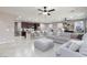 Open-concept living room featuring tile floors and seamless kitchen access, perfect for entertaining at 7525 Campbell Ranch Ave, Las Vegas, NV 89179